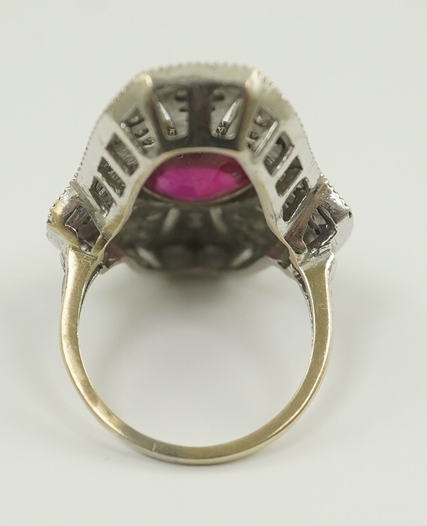 A gold, cabochon ruby and diamond cluster set upfinger ring